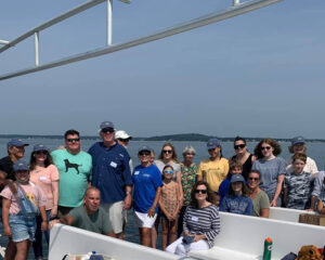 large group of people on a boat whale watching