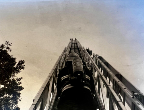 Ava's photo of a firefighter climbing a ladder.