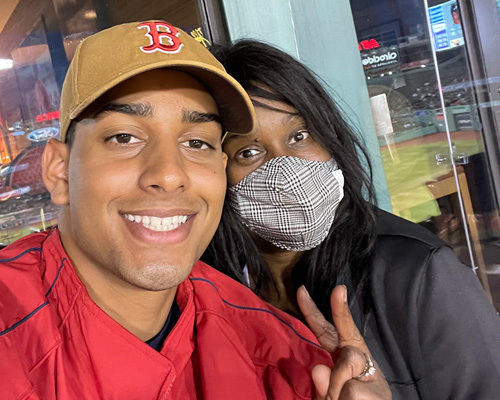 two people smiling at a red sox game